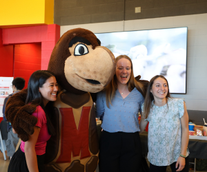 Three bioengineering students pose for a picture with Testudo.