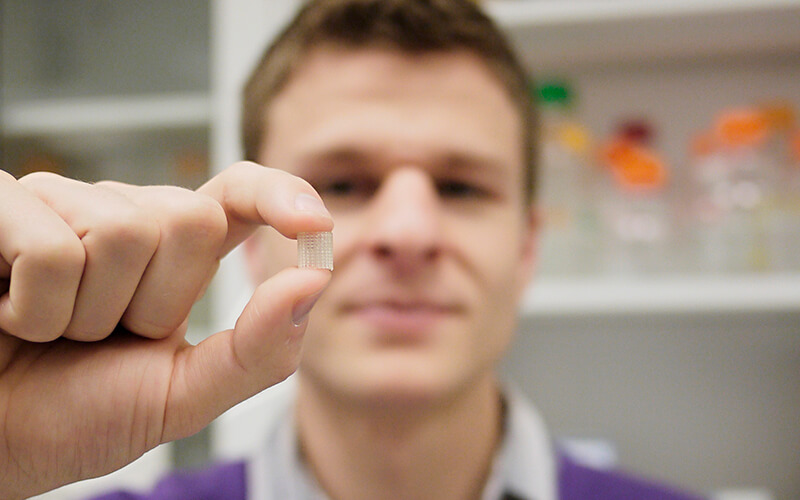 BIOE Graduate Student Holds a 3D Printed Vascular Graft