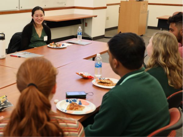 A group of students talk with a bioengineering alumni at a DEIB round table event.