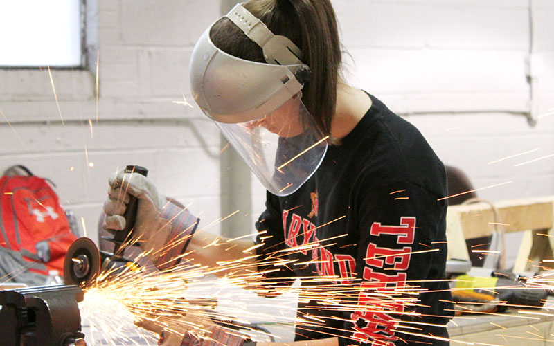 Concrete canoe team member welding