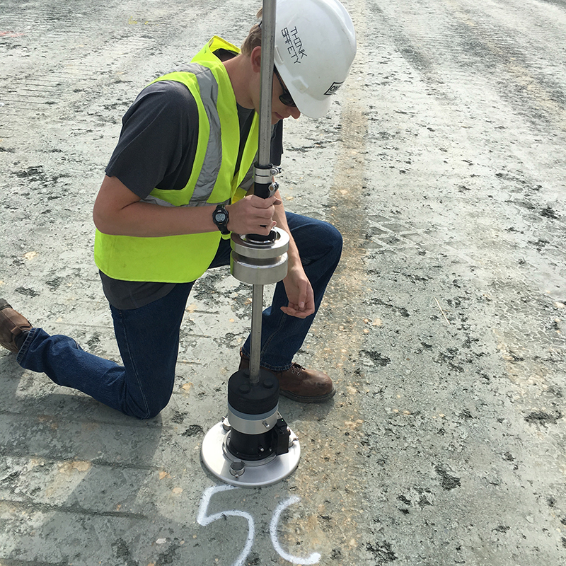 Student conducting pavement research