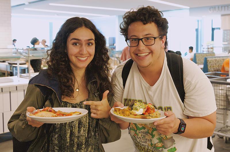 Two connector students with plates in hand