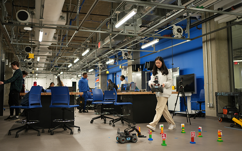 a student tests out a small remote controlled vehicle design