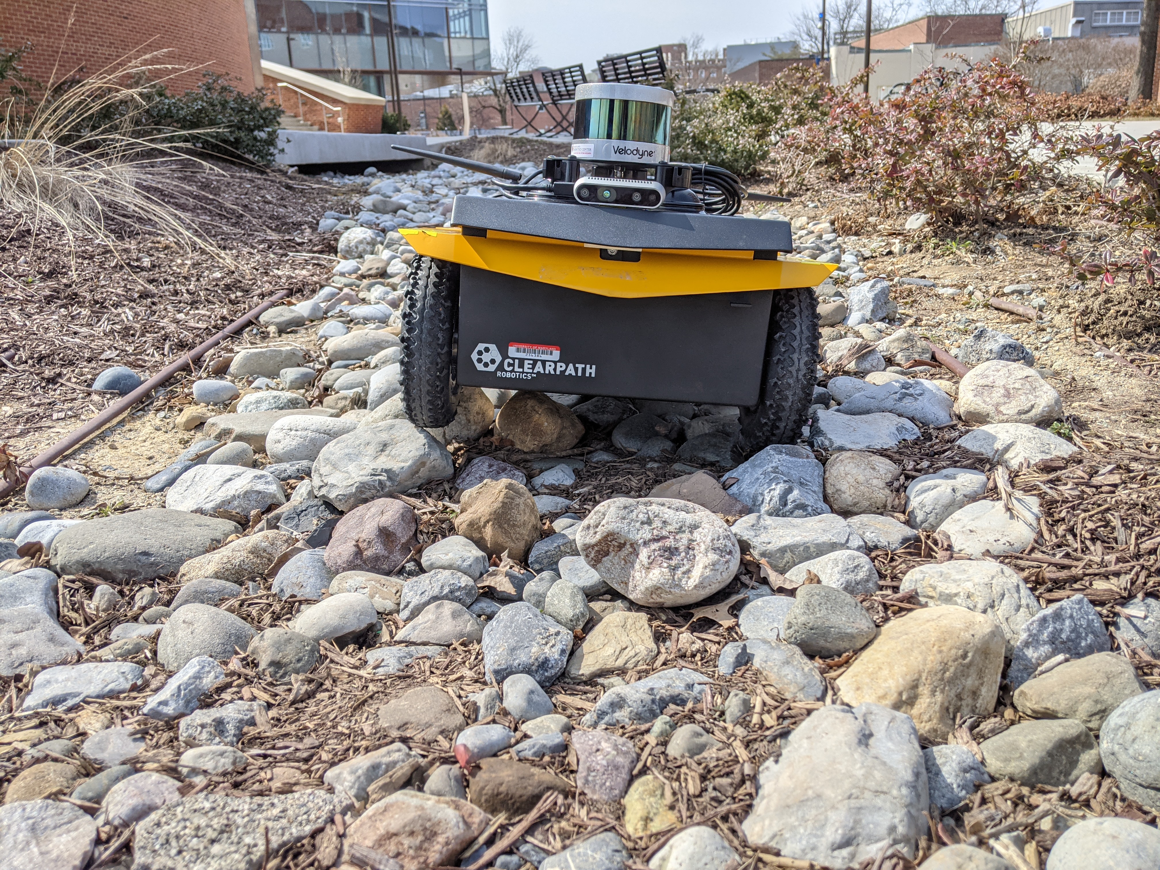 A small robot riding over an uneven rocky terrain