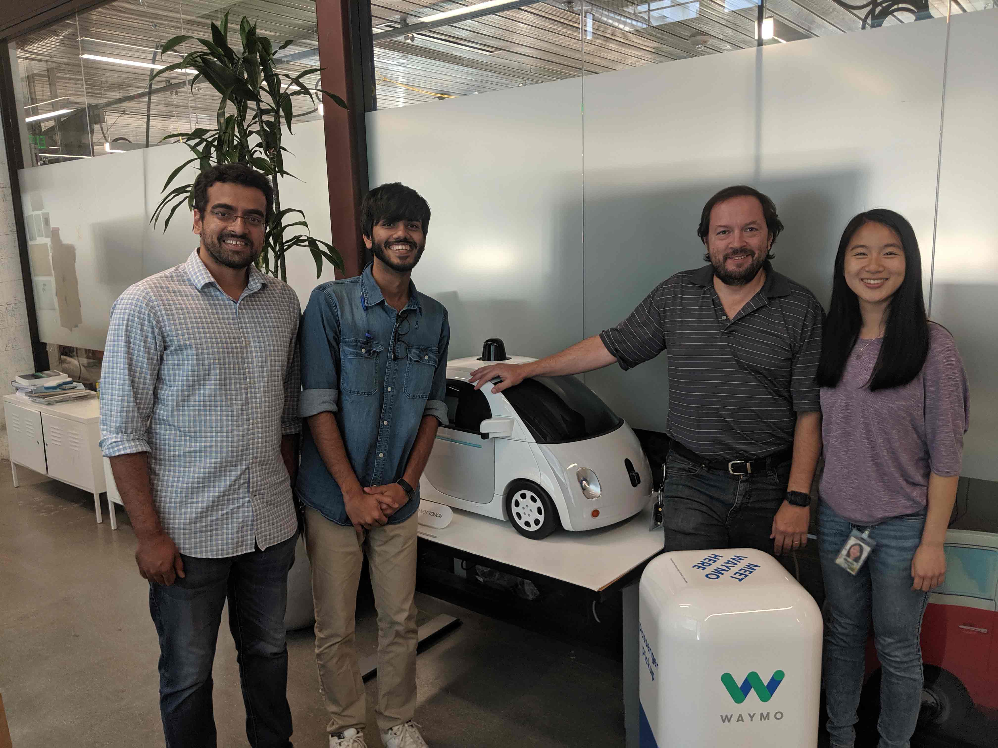 Yakeen Jain with colleagues and the Waymo Car