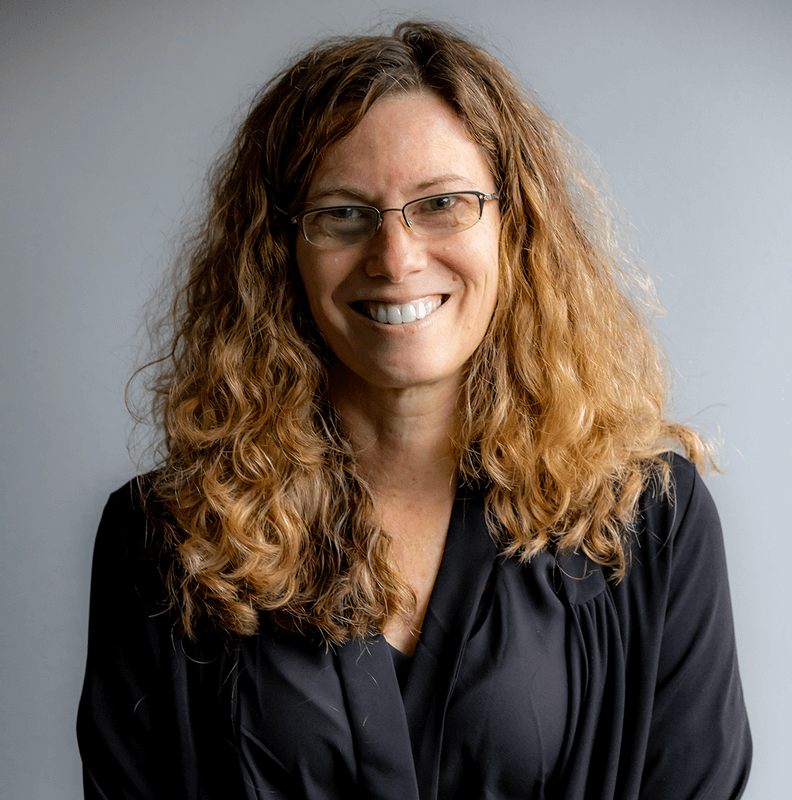 a headshot of Carole Teolis in a black shirt