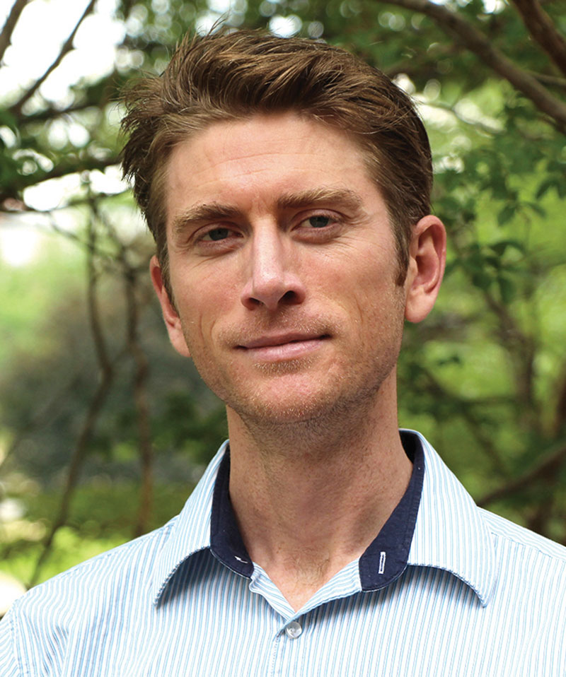 Headshot of Stuart Laurence wearing a blue button down shirt