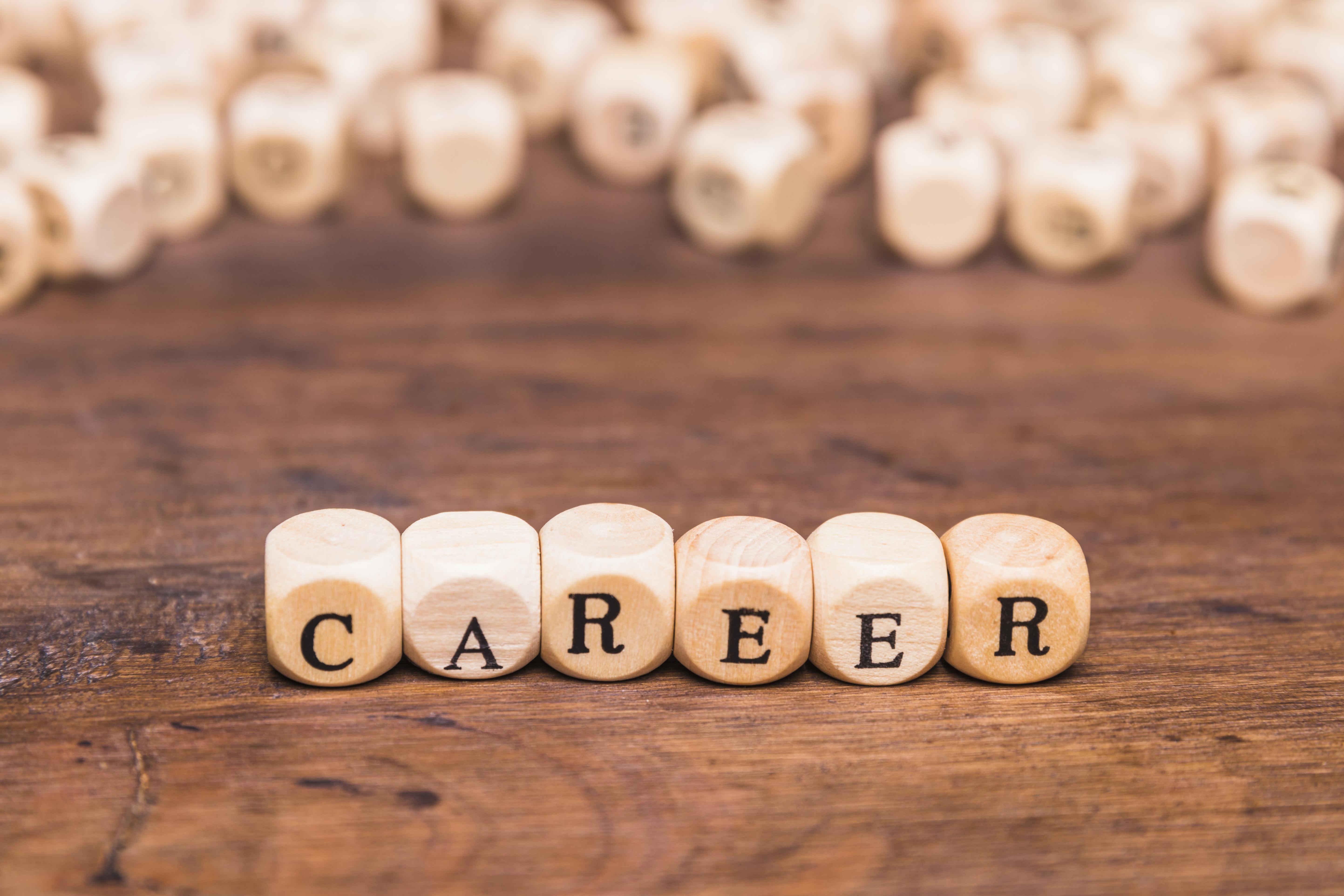 the word "career" with each letter appearing on six wooden dices