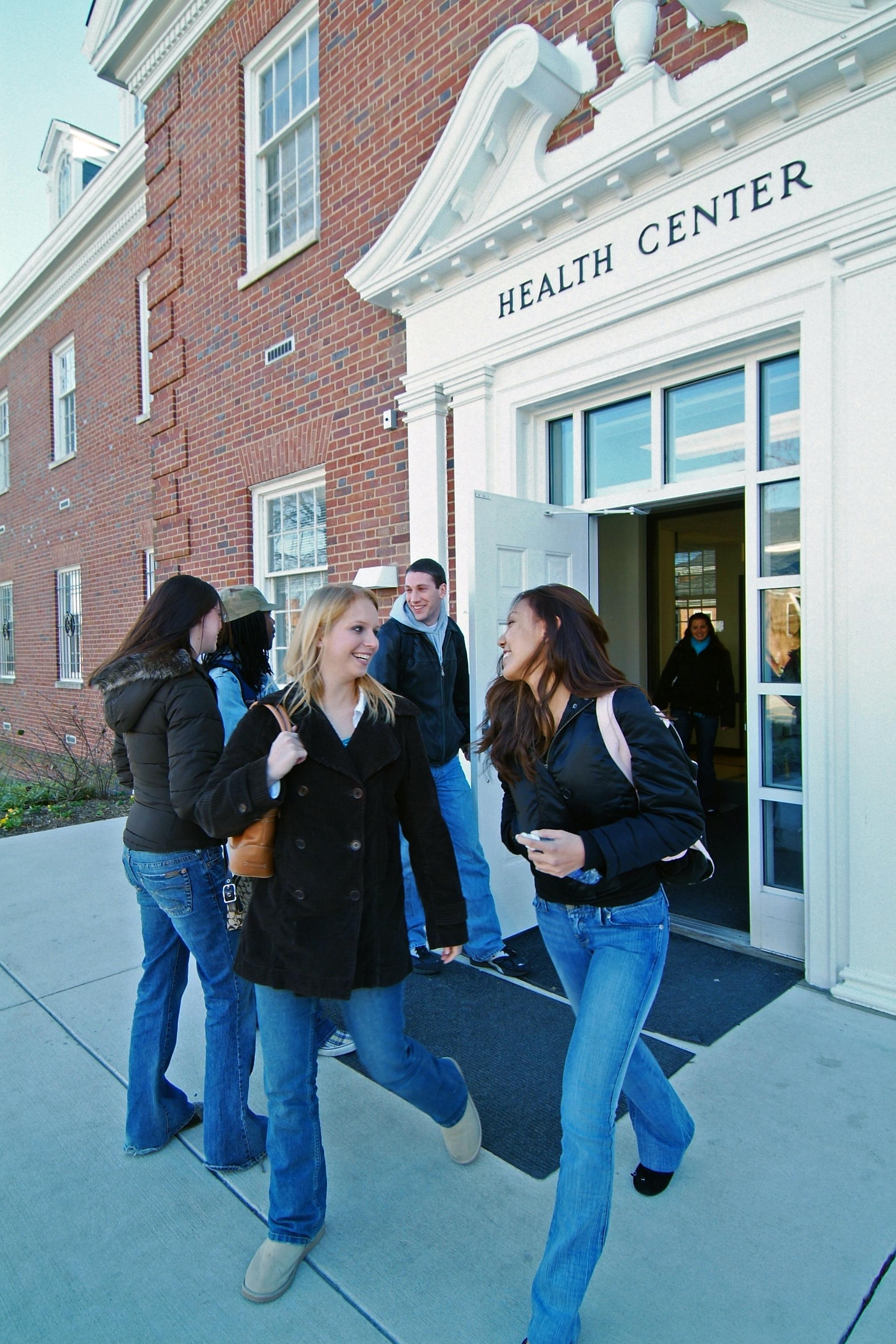 a photo of students standing outside of the Health Center building