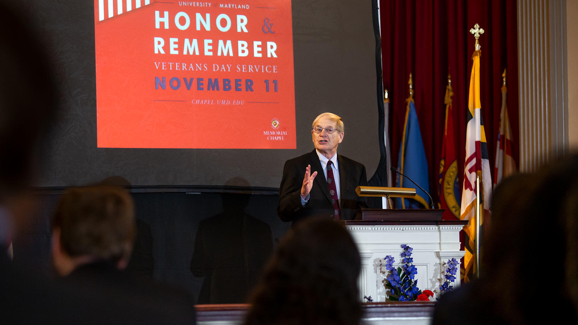 Col. Jack Baker speaks at the podium